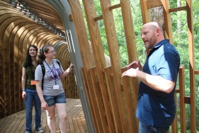 Josh Siebert, principal at Modus Studio, gives the Design Camp students a tour of the new tree house that was design by his firm.