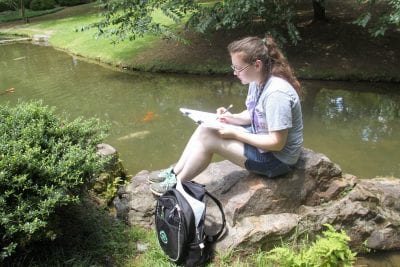 Student Keilah Barney sketches in the Garden of the Pine Wind at Garvan Woodland Gardens.